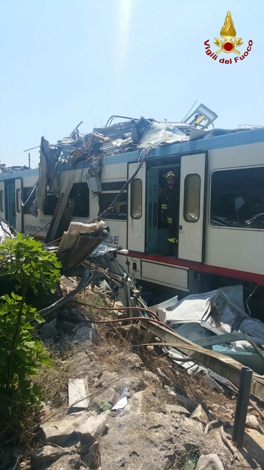 Firefighters work at the site where two passenger trains collided in the middle of an olive grove in the southern village of Corato, near Bari, Italy, in this handout picture released by Italian Firefighters July 12, 2016. Italian Firefighters/Handout via Reuters ATTENTION EDITORS - THIS PICTURE WAS PROVIDED BY A THIRD PARTY. FOR EDITORIAL USE ONLY.