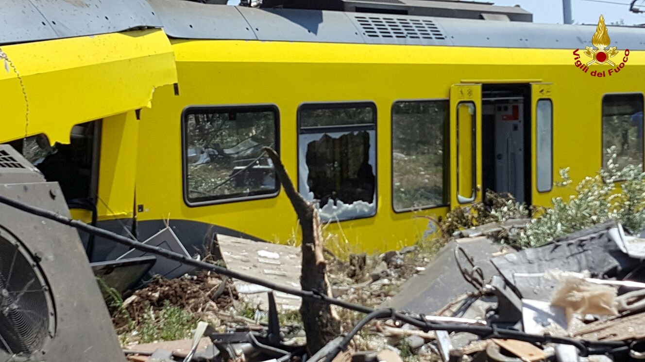 A damaged passenger train is seen after a collision with another in the middle of an olive grove in the southern village of Corato, near Bari, Italy, in this handout picture released by Italian Firefighters July 12, 2016. Italian Firefighters/handout via Reuters ATTENTION EDITORS - THIS PICTURE WAS PROVIDED BY A THIRD PARTY. FOR EDITORIAL USE ONLY.