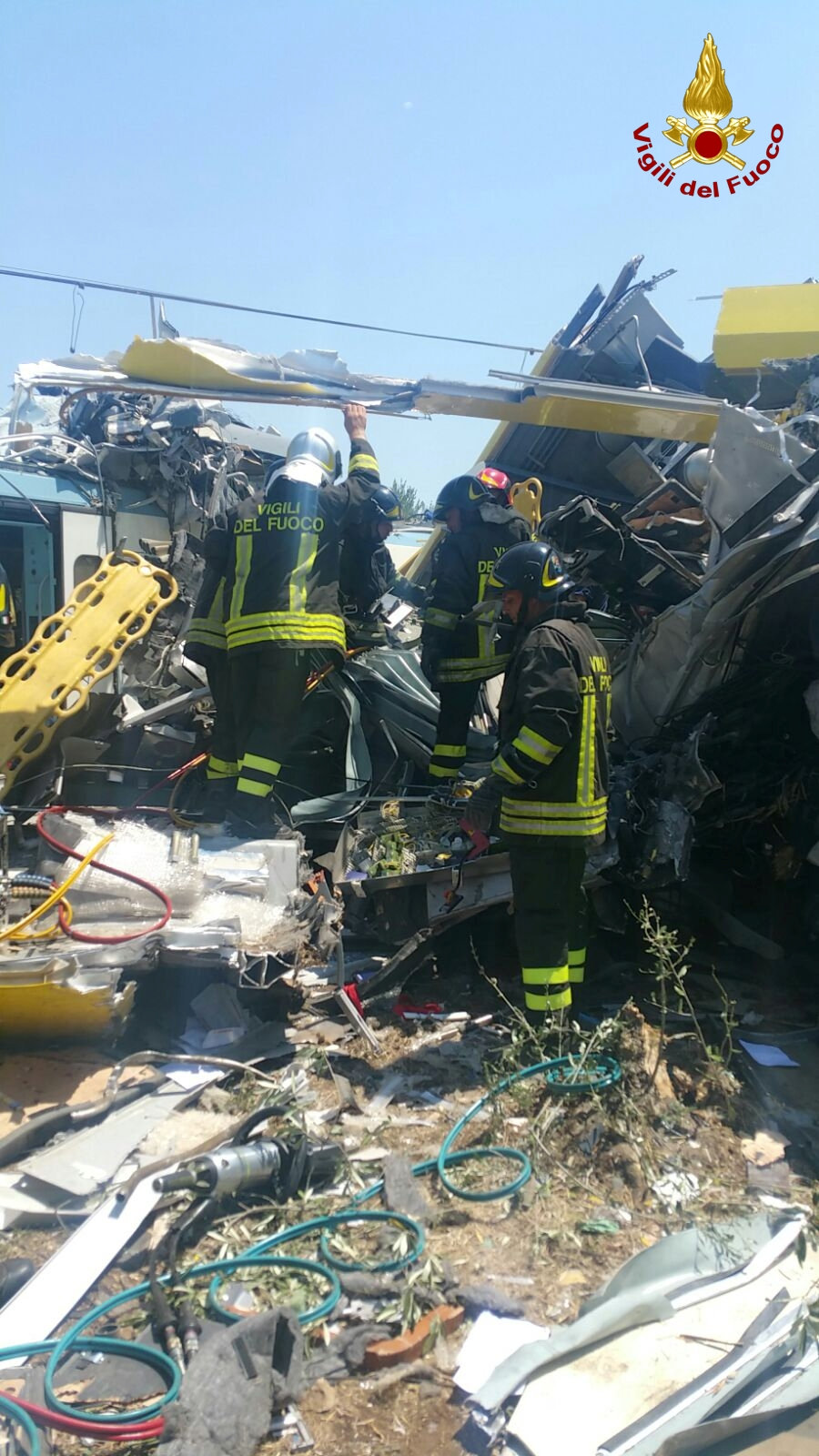 Firefighters work at the site where two passenger trains collided in the middle of an olive grove in the southern village of Corato, near Bari, Italy, in this handout picture released by Italian Firefighters July 12, 2016. Italian Firefighters/Handout via Reuters ATTENTION EDITORS - THIS PICTURE WAS PROVIDED BY A THIRD PARTY. FOR EDITORIAL USE ONLY.