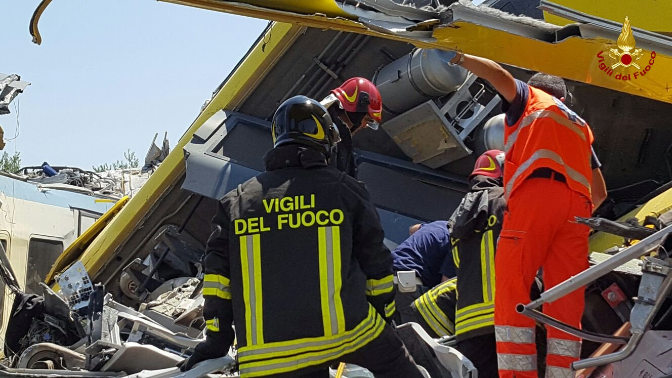 Firefighters work at the site where two passenger trains collided in the middle of an olive grove in the southern village of Corato, near Bari, Italy, in this handout picture released by Italian Firefighters July 12, 2016. Italian Firefighters/Handout via Reuters ATTENTION EDITORS - THIS PICTURE WAS PROVIDED BY A THIRD PARTY. FOR EDITORIAL USE ONLY.