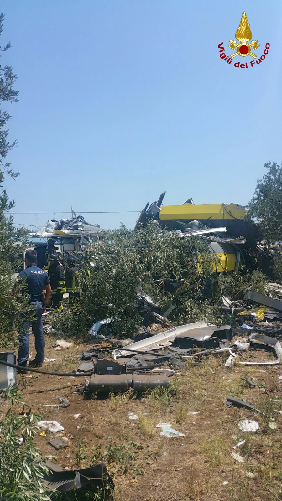 Firefighters work at the site where two passenger trains collided in the middle of an olive grove in the southern village of Corato, near Bari, Italy, in this handout picture released by Italian Firefighters July 12, 2016. Italian Firefighters/Handout via Reuters ATTENTION EDITORS - THIS PICTURE WAS PROVIDED BY A THIRD PARTY. FOR EDITORIAL USE ONLY.