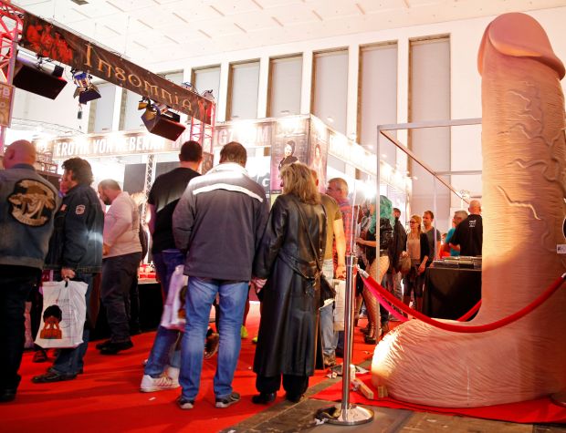 Visitors of the erotic fair "Venus" pass by a huge rubber penis in Berlin, Germany, October 14, 2016. REUTERS/Axel Schmidt TEMPLATE OUT