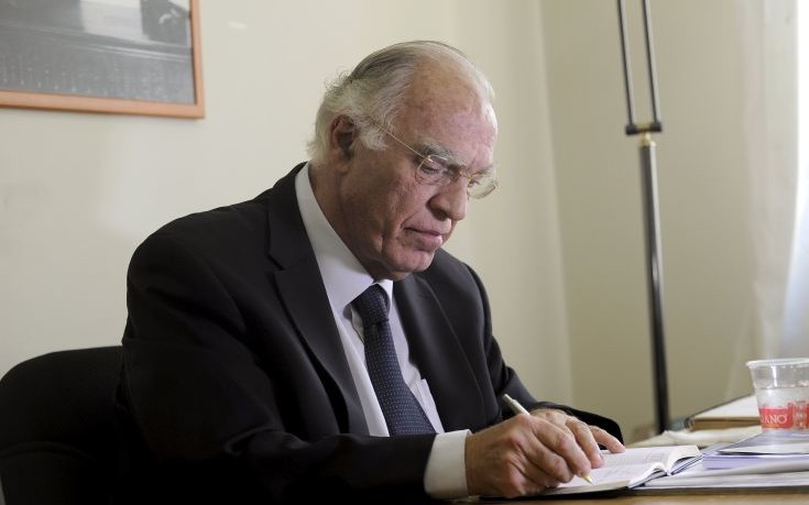 Leader of the Union of Centrists party Leventis takes notes before an interview with Reuters at the party headquarters in Athens