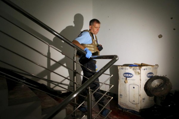 A U.N. official walks at a staircase covered in blood in the Radisson hotel in Bamako