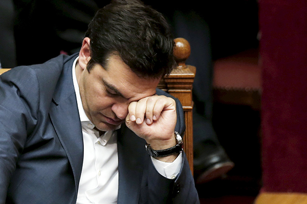 Greek PM Tsipras reacts during a parliamentary session in Athens