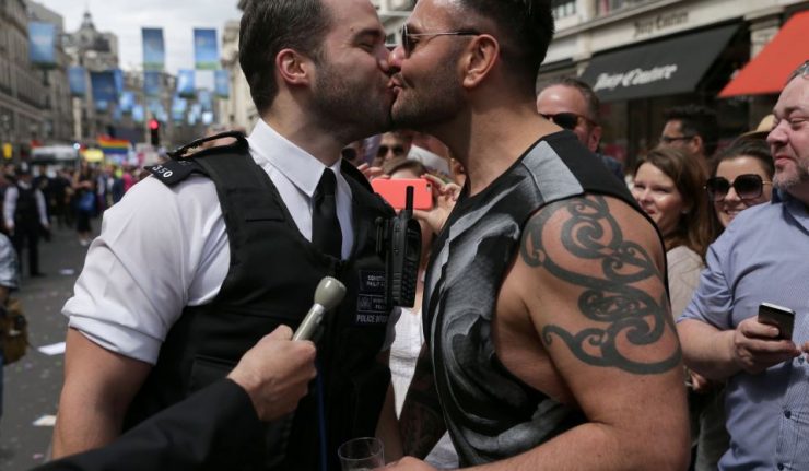 A policeman (left) kisses his boyfriend after proposing to him during the Pride in London parade, as it makes its way through the streets of central, London. PRESS ASSOCIATION Photo. Picture date: Saturday June 25, 2016. See PA story POLICE Pride. Photo credit should read: Daniel Leal-Olivas/PA Wire