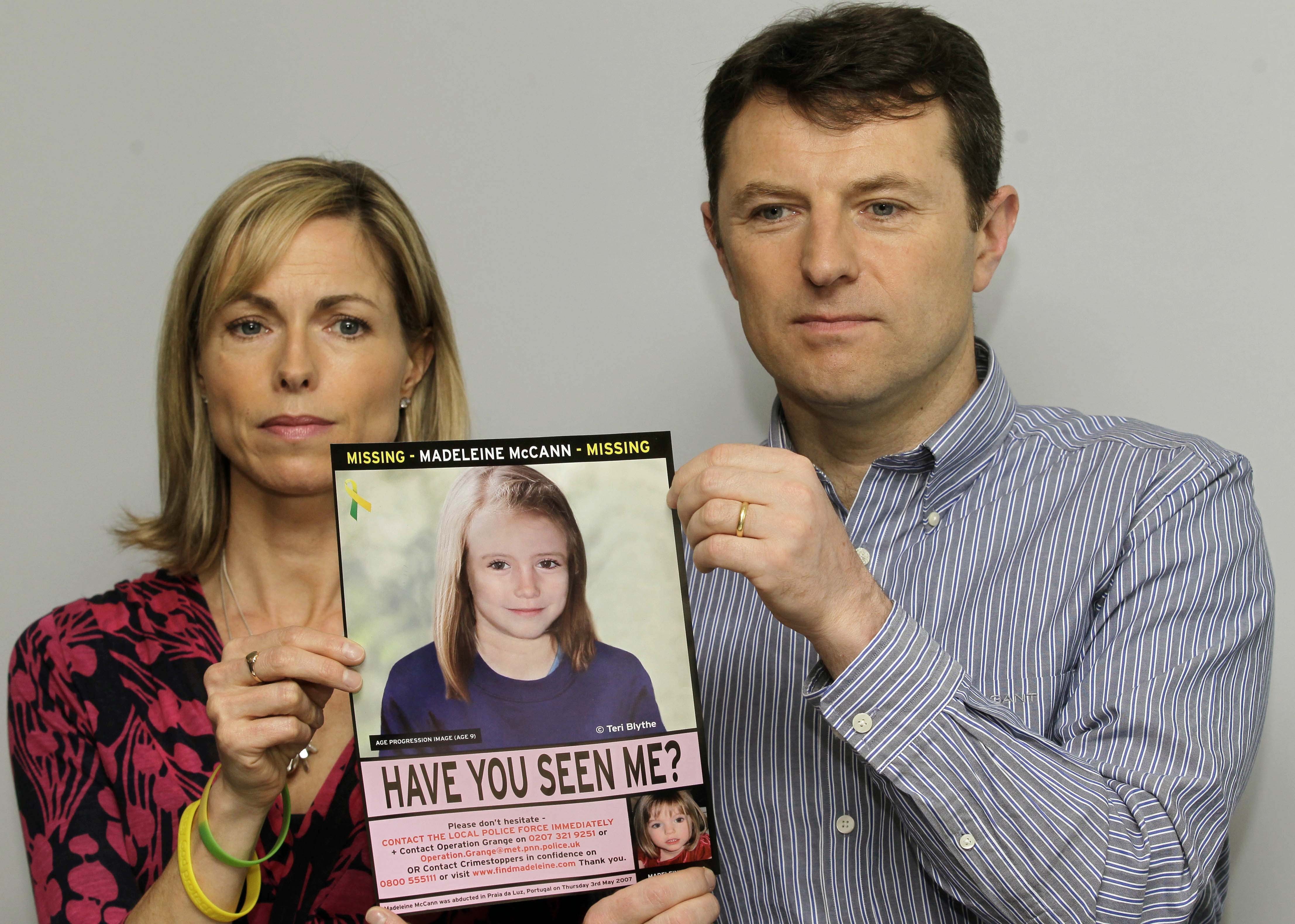 Kate and Gerry McCann pose with a missing poster of their daughter Madeleine as talk to the media in London Wednesday, May 2, 2012 to mark their daughter Madeleine's birthday and the 5th anniversary of their daughter disappearance during a family vacation in southern Portugal in May 2007 shortly before her fourth birthday. (AP Photo/Sang Tan)