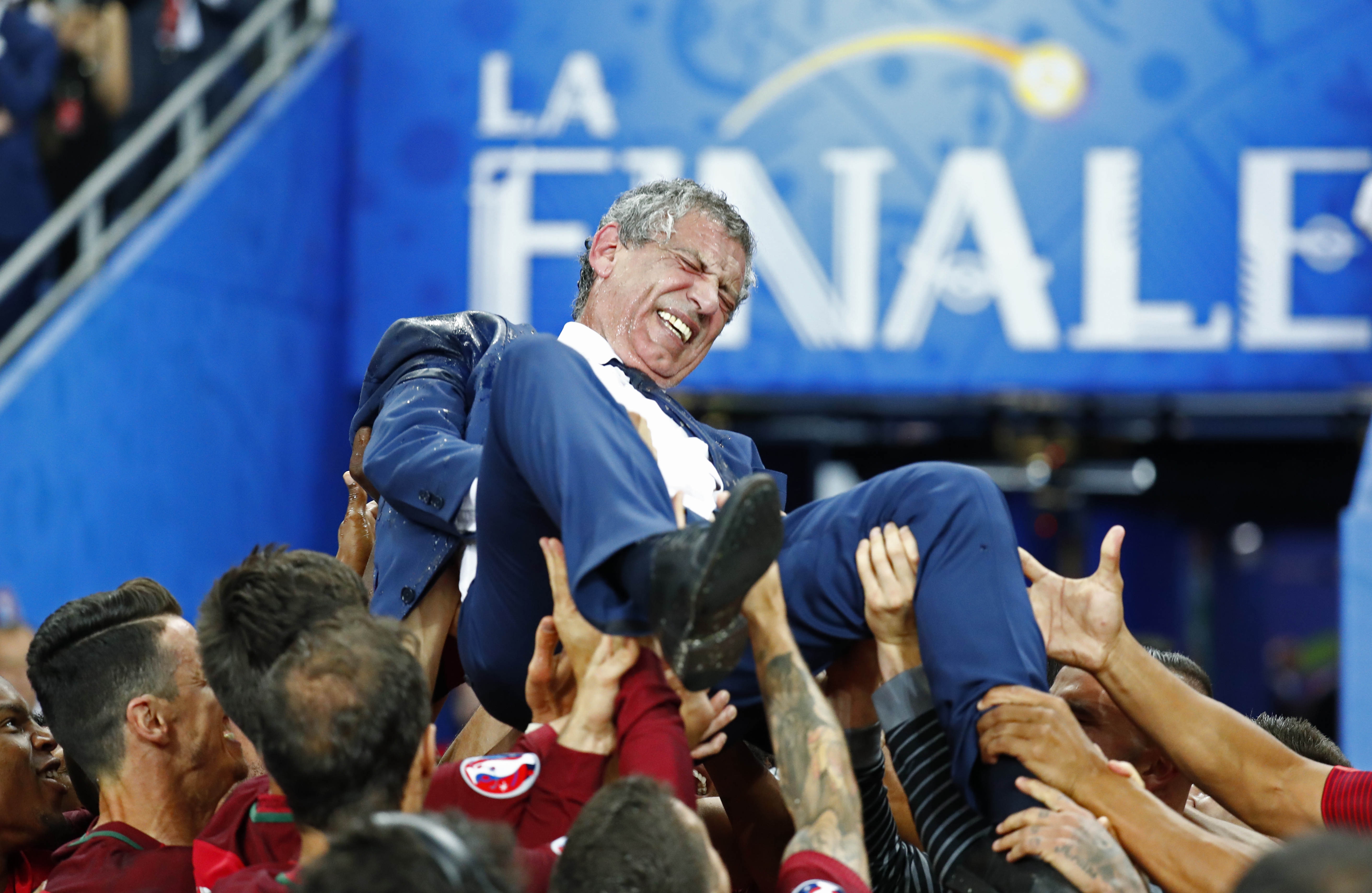 Football Soccer - Portugal v France - EURO 2016 - Final - Stade de France, Saint-Denis near Paris, France - 10/7/16 Portugal head coach Fernando Santos is lifted up by his players after winning Euro 2016  REUTERS/Kai Pfaffenbach Livepic