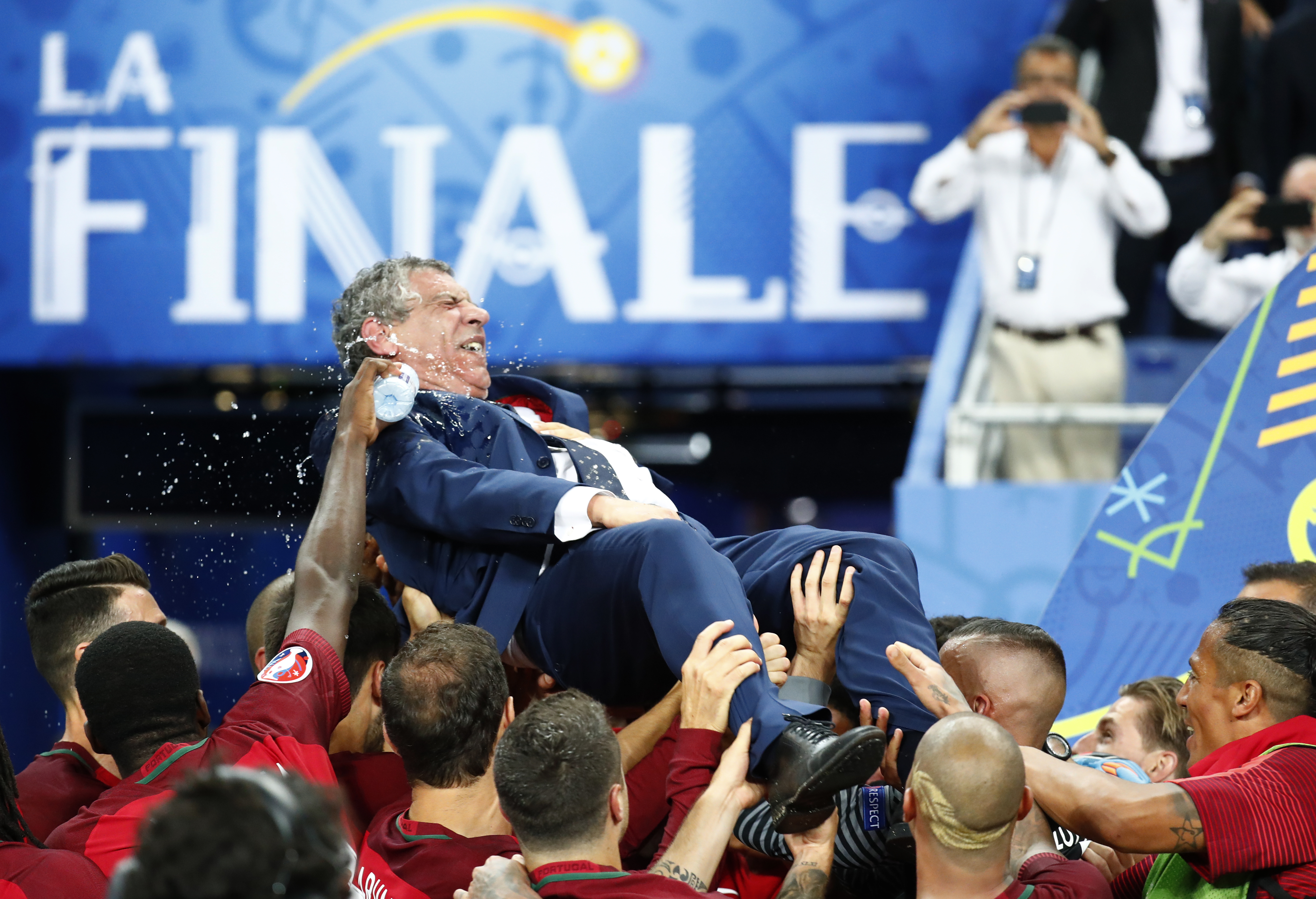 Football Soccer - Portugal v France - EURO 2016 - Final - Stade de France, Saint-Denis near Paris, France - 10/7/16 Portugal head coach Fernando Santos is lifted up by his players after winning Euro 2016  REUTERS/Kai Pfaffenbach Livepic