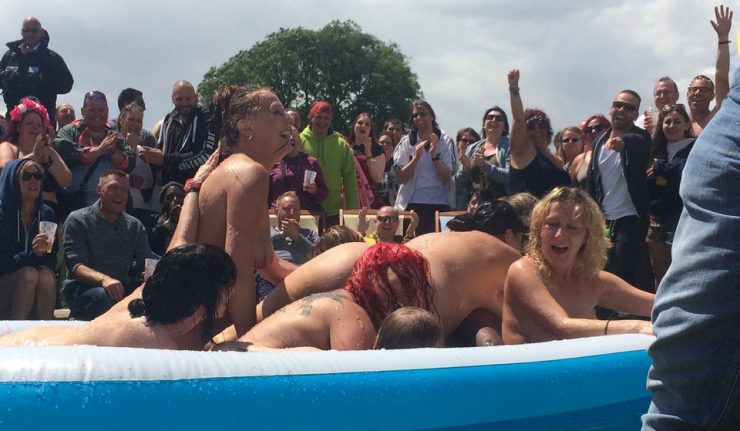 Europe's largest gathering of 'swingers' meet at their annual get-together - Swingfields - held in the tiny village of Trellech, near Monmouth, Wales. A single male cavorts with a number of females in a bath of slime as onlookers cheer them on. Pic © Neil Hope/www.divingimages.co.uk Tel: 01752 814338 Mob: 07505 263 011 Email: neil.hope@taltalk.net Web: www.divingimages.co.uk