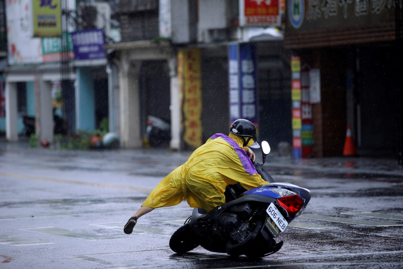 A motorcyclist falls along a road as Typhoon Megi hits Hualien, eastern Taiwan, September 27, 2016. REUTERS/Tyrone Siu