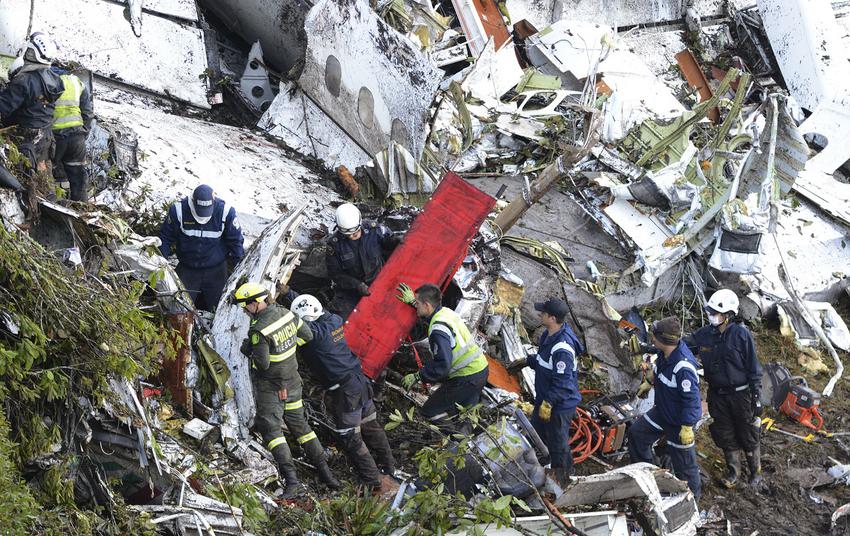 CORRECTS TO REMOVE DEATH TOLL OF 75 AFTER NUMBER OF DEATH TOLL WAS LOWERED BY COLOMBIAN OFFICIALS - Rescue workers comb through the wreckage site of an airplane crash, in La Union, a mountainous area near Medellin, Colombia, Tuesday , Nov. 29, 2016. The chartered plane was carrying a Brazilian soccer team to the biggest match of its history when it crashed into a Colombian hillside and broke into pieces, Colombian officials said Tuesday. (AP Photo/Fernando Vergara)