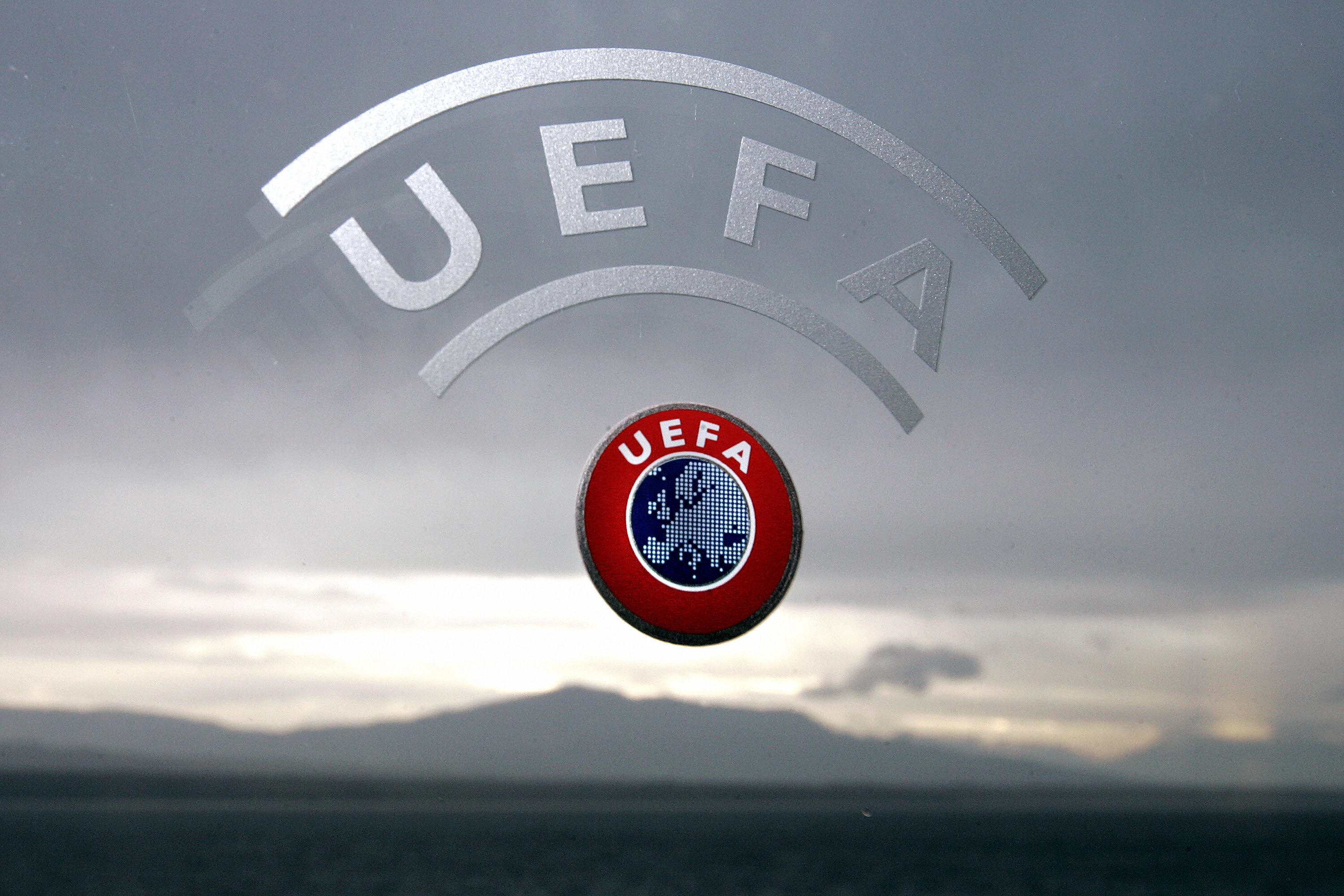 Nyon, SWITZERLAND:  A UEFA logo is seen with Geneva Lake and Alps as background 08 December 2006 during a press conference closing a two days Executive committee meeting of the European football federation at the headquarters in Nyon. AFP PHOTO / FABRICE COFFRINI  (Photo credit should read FABRICE COFFRINI/AFP/Getty Images)