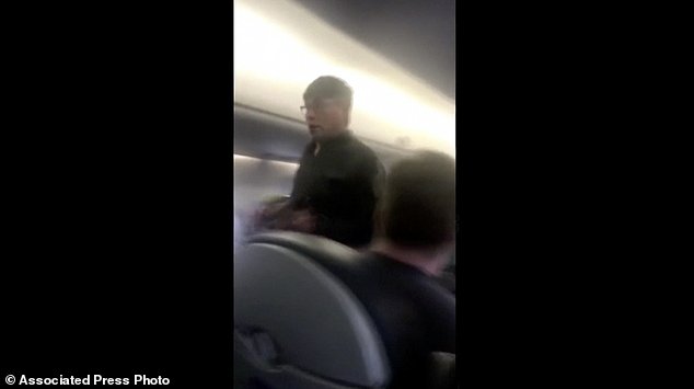 This Sunday, April 9, 2017, image made from a video provided by Audra D. Bridges shows a passenger who was removed from a United Airlines flight in Chicago. Video of police officers dragging the passenger from an overbooked United Airlines flight sparked an uproar Monday on social media, and a spokesman for the airline insisted that employees had no choice but to contact authorities to remove the man. (Audra D. Bridges via AP)