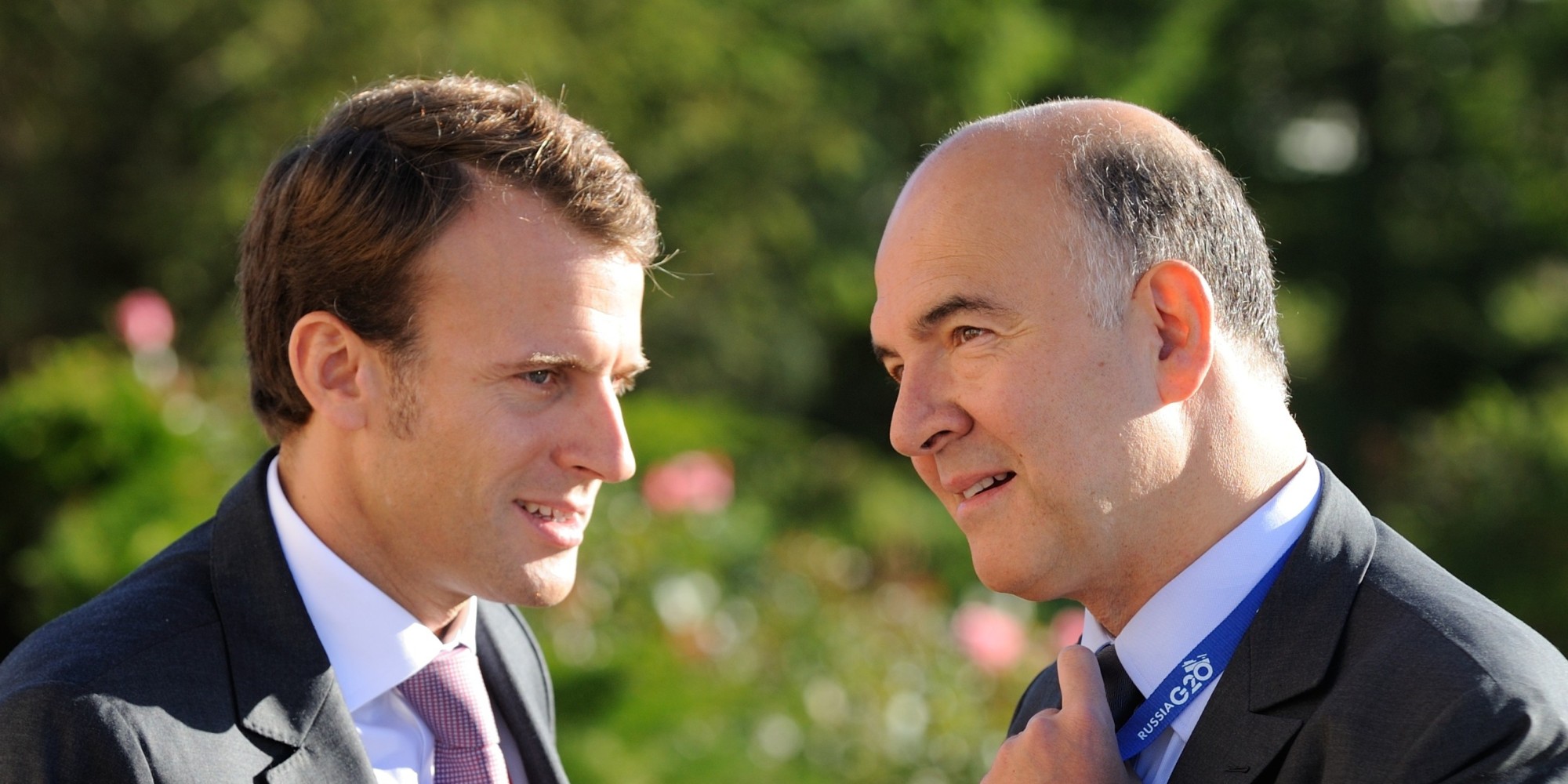 French President's deputy General Secretary Emmanuel Macron (L) and French Economy, Finance and Foreign Trade Minister Pierre Moscovici (R) chat during the G20 summit on September 6, 2013 in Saint Petersburg.  AFP PHOTO / JACQUES WITT        (Photo credit should read JACQUES WITT/AFP/Getty Images)