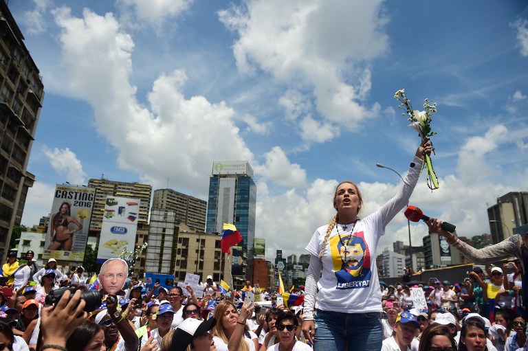 The wife of imprisoned opposition leader Leopoldo Lopez, Lilian Tintori, takes part in a women's march aimed to keep pressure on President Nicolas Maduro, whose authority is being increasingly challenged by protests and deadly unrest, in Caracas on May 6, 2017. The death toll since April, when the protests intensified after Maduro's administration and the courts stepped up efforts to undermine the opposition, is at least 36 according to prosecutors.  / AFP PHOTO / RONALDO SCHEMIDT