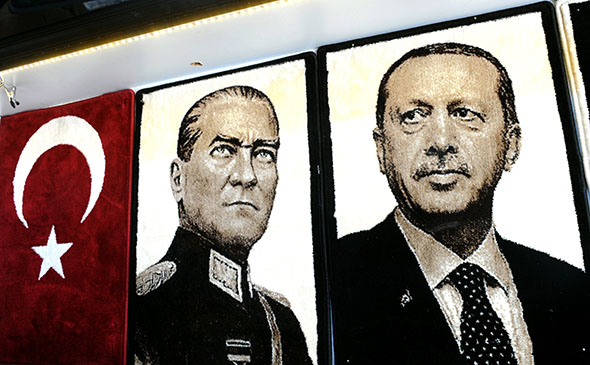 Embroidered images of the founder of modern Turkey Mustafa Kemal Ataturk (L) and Turkey's Prime Minister Recep Tayyip Erdogan (R) are displayed in a shop in the Gaziantep market on January 17, 2014 in Gaziantep, near the Turkish-Syrian border.