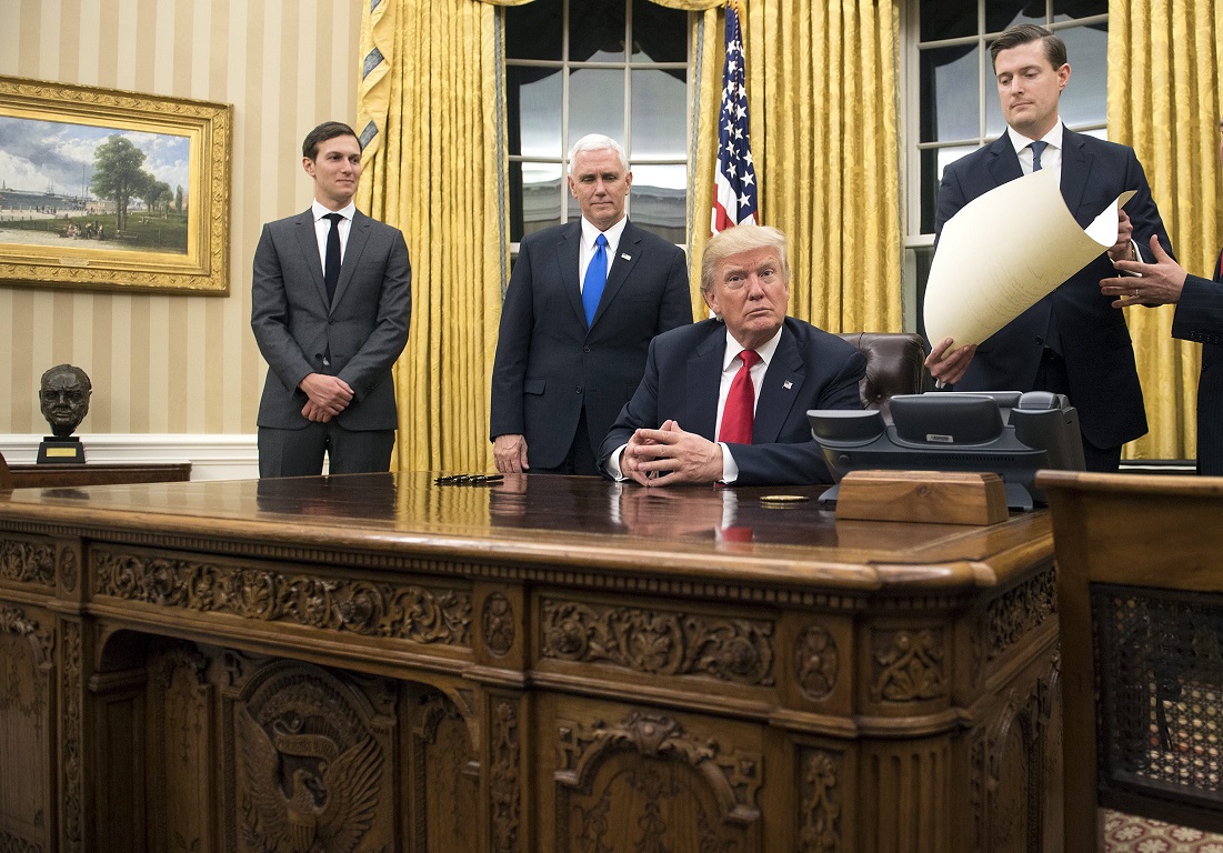 epa05736770 US President Donald J. Trump (C) prepares to sign a confirmation for Defense Secretary James Mattis, after Trump was sworn in as the 45th President of the United States in the Oval Office at the White House in Washington, DC, USA, 20 January 2017. Trump won the 08 November 2016 election to become the next US President.  EPA/KEVIN DIETSCH / POOL