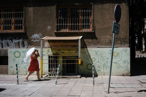 A woman protects herself from the sun with a scarf as a heatwave strikes Bulgaria's capital Sofia on June 30, 2017. 
Half a degree Celsius of global warming has been enough to increase heat waves and heavy rains in many regions of the planet, researchers reported on June 30, 2017.  / AFP PHOTO / Dimitar DILKOFF