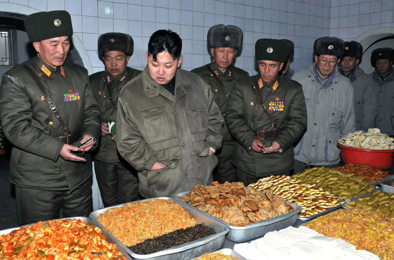 In this undated photo released by the Korean Central News Agency and distributed in Tokyo by the Korea News Service on Thursday, Jan. 19, 2012, North Korean leader Kim Jong Un, center, looks at food items at an undisclosed location in North Korea. KCNA reported he was inspecting a military unit. (AP Photo/Korean Central News Agency via Korea News Service) JAPAN OUT UNTIL 14 DAYS AFTER THE DAY OF TRANSMISSION