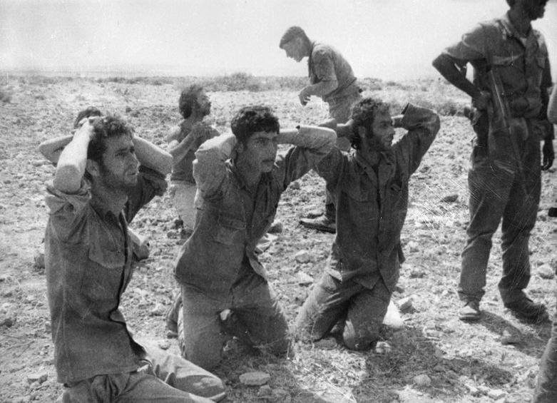 In this image released by the Cyprus Press and Information Office on Monday, Aug. 10, 2009, show five Greek Cypriot soldiers are pictured surrendering to advancing Turkish troops near Kiados or (Tziaos) village during the second phase of Turkey's invasion of the island that started on August 14, 1974. The remains of the five soldiers were recently identified after being unearthed from an abandoned well along with those of 14 other individuals in the breakaway Turkish Cypriot north of the island. Cyprus' government spokesman Stefanos Stefanou urged Turkey to account for some 1,500 Greek Cypriots who vanished during the invasion. Around 500 Turkish Cypriots also dissapeared mainly during inter-ethnic clashes in the early 1960s. Cyprus was ethnically split in 1974 when Turkey invaded in response to a coup by supporters of union with Greece. (AP Photo/Cyprus Press and Information Office, HO)