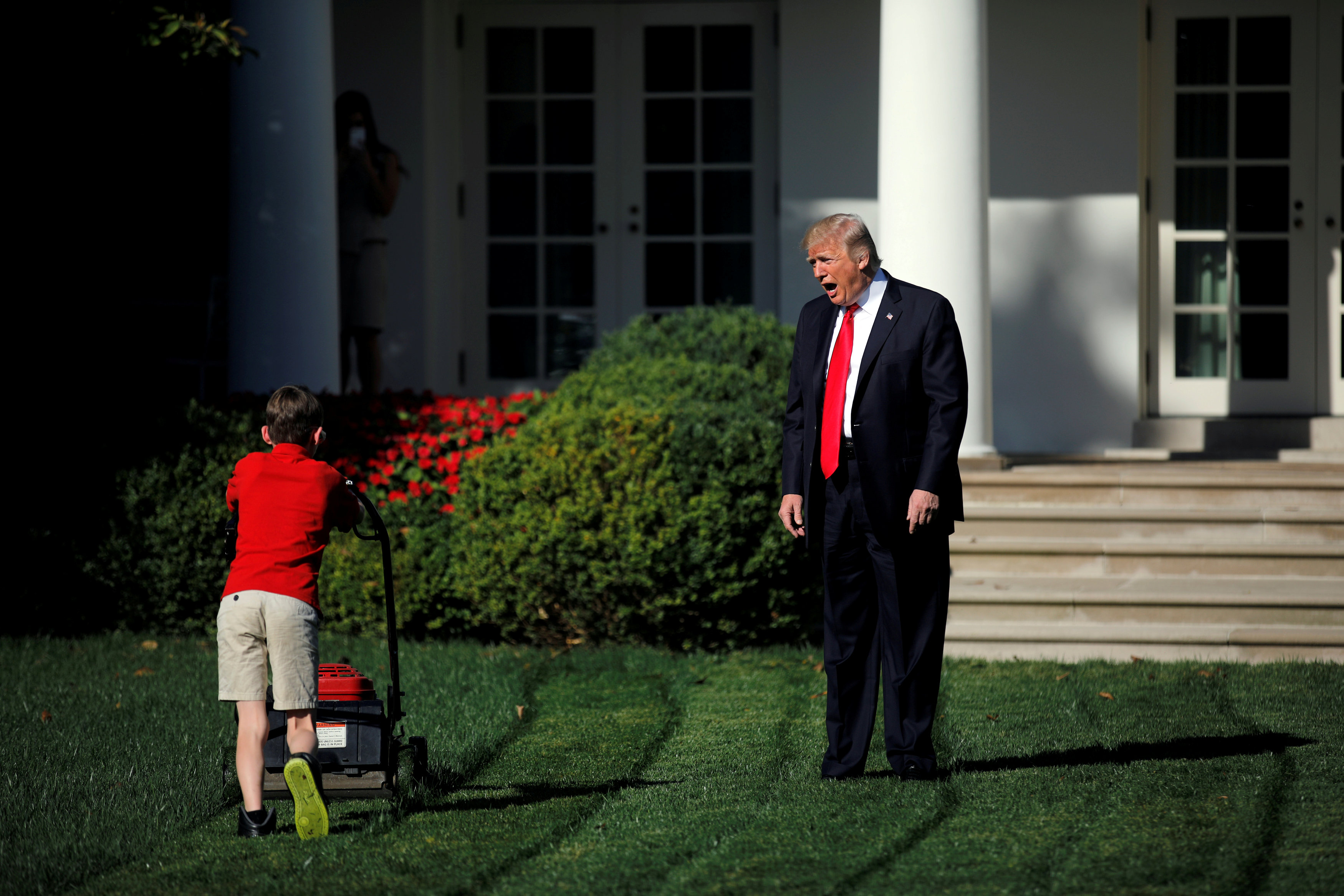 U.S. President Donald Trump welcomes 11-years-old Frank Giaccio as he cuts the Rose Garden grass at the White House in Washington, U.S., September 15, 2017. Frank, who wrote a letter to Trump offering to mow the White House lawn, was invited to work for a day at the White House along the National Park Service staff. REUTERS/Carlos Barria     TPX IMAGES OF THE DAY