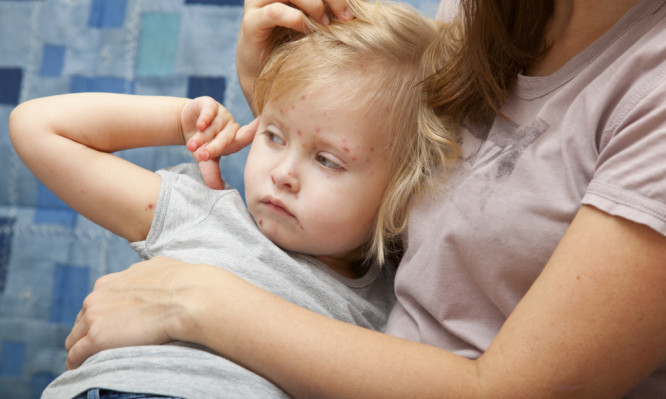 A sick girl in the arms of her mother