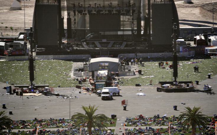 Debris is strewn through the scene of a mass shooting at a music festival near the Mandalay Bay resort and casino on the Las Vegas Strip, Monday, Oct. 2, 2017, in Las Vegas. (AP Photo/John Locher)