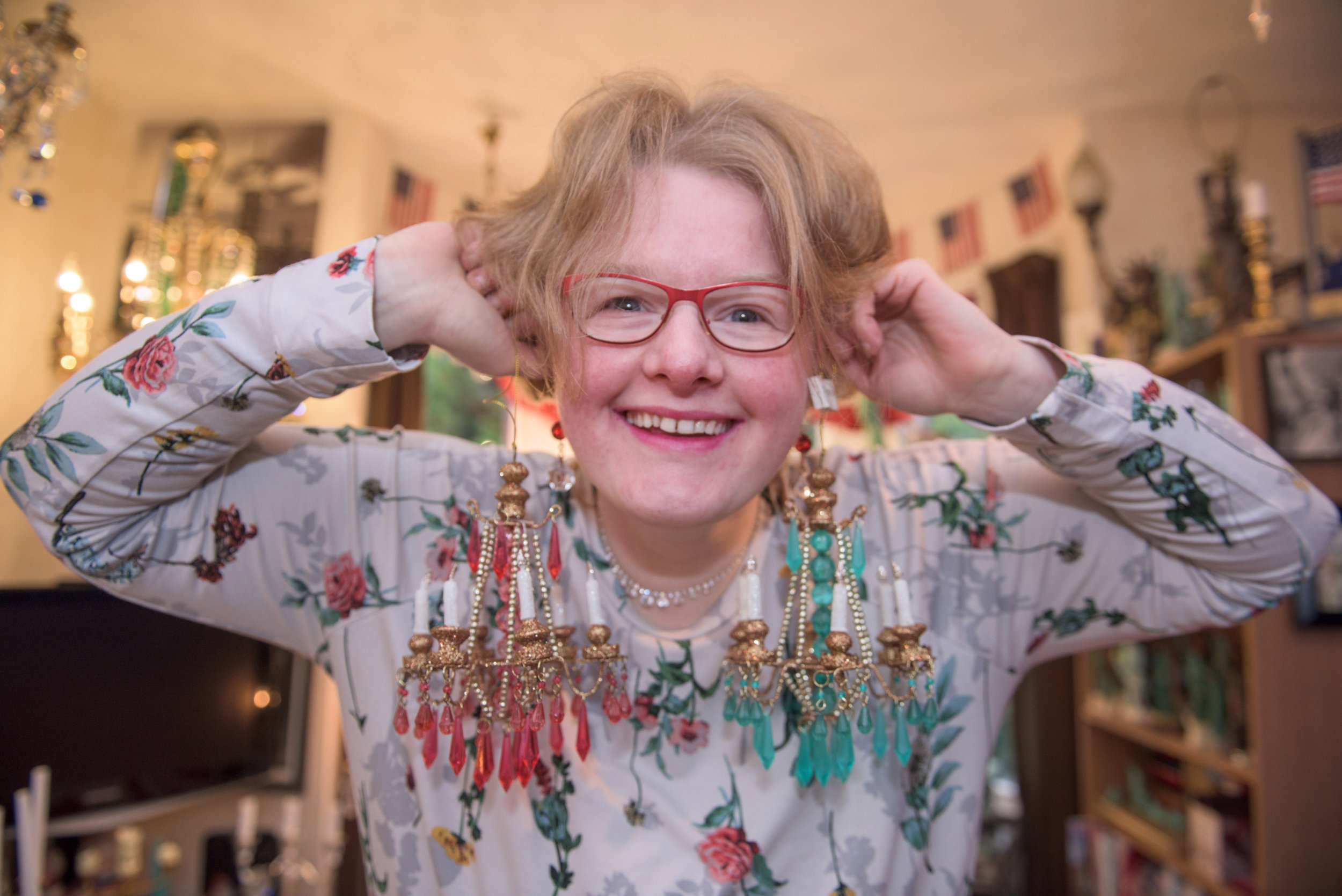 **MANDATORY BYLINE** Pic by Michael Scott/Caters News - (PICTURED: Amanda Liberty, 33, from Leeds, has lots of fun with her chandeliers. Pic taken 01/12/2017.) - A woman has fallen in love with a 90-year-old chandelier she bought online - and the inseparable pair are now engaged. Amanda Liberty, 33, has been in a relationship with the 70cm wide chandelier, named Lumiere, for just over 12 months after spotting it on eBay. She claims it was love at first sight and after spending 400 pounds on the antique from Germany, Lumiere hasnt left her side since. SEE CATERS COPY