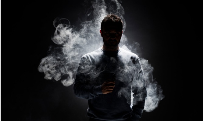 man-and-smoke-fragments-on-a-black-background-picture-id680195090