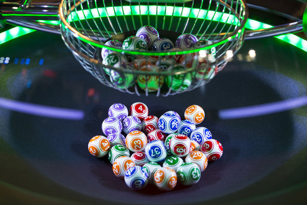 Colourful lottery balls in a rotating bingo machine.