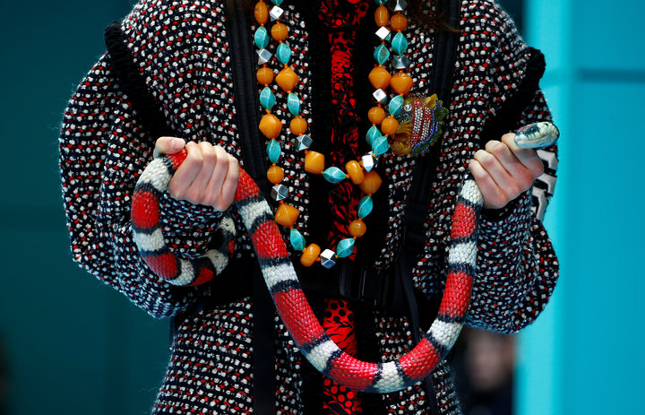 A model holds a snake as she presents a creation from the Gucci Autumn/Winter 2018 women collection during Milan Fashion Week in Milan, Italy February 21, 2018. REUTERS/Tony Gentile