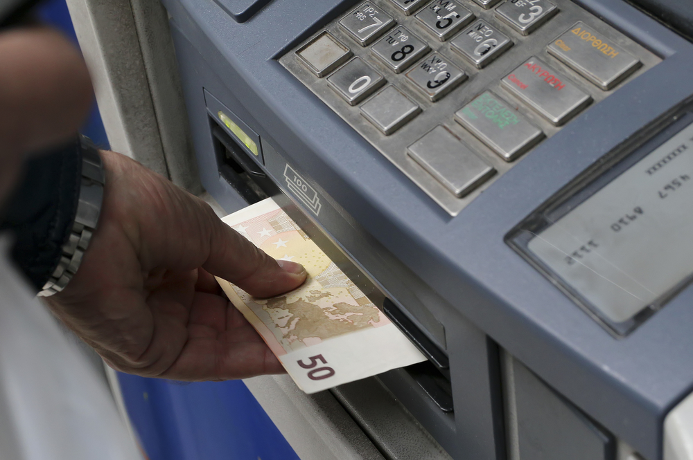 THESSALONIKI, GREECE,JUN 27 2015: People stand in a queue to use the ATMs of a bank. Greece's fraught bailout talks with its creditors took a dramatic turn, with the government announcing a referendum