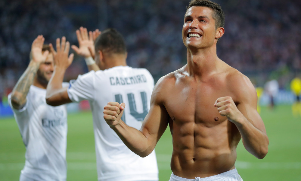 Real Madrid's Cristiano Ronaldo celebrates after scoring the winning penalty shot during the Champions League final soccer match between Real Madrid and Atletico Madrid at the San Siro stadium in Milan, Italy, Saturday, May 28, 2016. Real Madrid won 5-4 on penalties after the match ended 1-1 after extra time.    (AP Photo/Manu Fernandez) ORG XMIT: XAF257