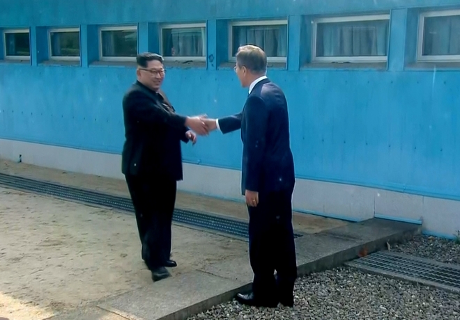 In this image taken from video provided by Korea Broadcasting System (KBS), North Korean leader Kim Jong Un, left,  shakes hands with South Korean President Moon Jae-in as Kim arrives at Panmunjom for their historic face-to-face talks Friday, April 27, 2018. Their discussions will be expected to focus on whether the North can be persuaded to give up its nuclear bombs.(Korea Broadcasting System via AP)