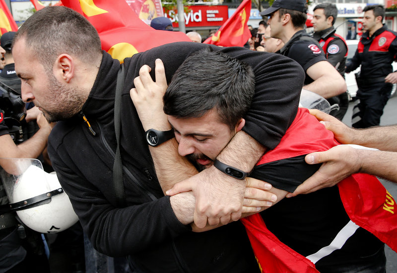 Police detain a demonstrator during May Day protests in Istanbul, Turkey, Tuesday, May 1, 2018. Workers and activists mark May Day with defiant rallies and marches for better pay and working conditions. (AP Photo/Lefteris Pitarakis)