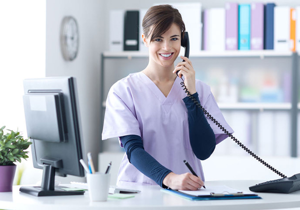 bigstock-Smiling-Receptionist-At-The-Cl-136924850