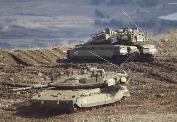 n-israeli-tank-in-a-firing-position-in-the-israeli-controlled-golan-heights-overlooking-the-syrian-village-of-bariqa-monday-nov-12-2012-the-israeli-military-says-syrian-mobile-artil