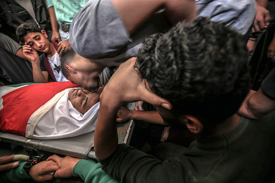 epaselect epa06733512 Friends and relatives of 15-year-old Palestinian Jamal Afaneh gather around his body during his funeral in Rafah refugee camp in the southern Gaza Strip, 13 May 2018. Afaneh died a day earlier in the hospital from his injuries after being shot on 11 May 2018 by Israeli troops during the protest near the border with Israel east Rafah town, southern Gaza Strip. Protesters call for the right of Palestinian refugees across the Middle East to return to homes they fled in the war surrounding the 1948 creation of Israel.  EPA/MOHAMMED SABER