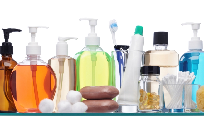 various personal hygiene products on glass shelf