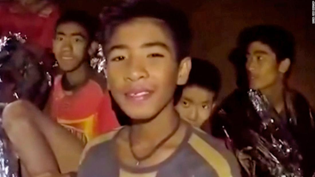 FILE - In this July 3, 2018, file image taken from video provided by the Royal Thai Navy Facebook Page, the boys smile as Thai Navy SEAL medic help injured children inside a cave in Mae Sai, northern Thailand. The group was discovered July 2 after 10 days totally cut off from the outside world, and while they are for the most physically healthy, experts say the ordeal has likely taken a mental toll that could worsen the longer the situation lasts. (Royal Thai Navy Facebook Page via AP, File)