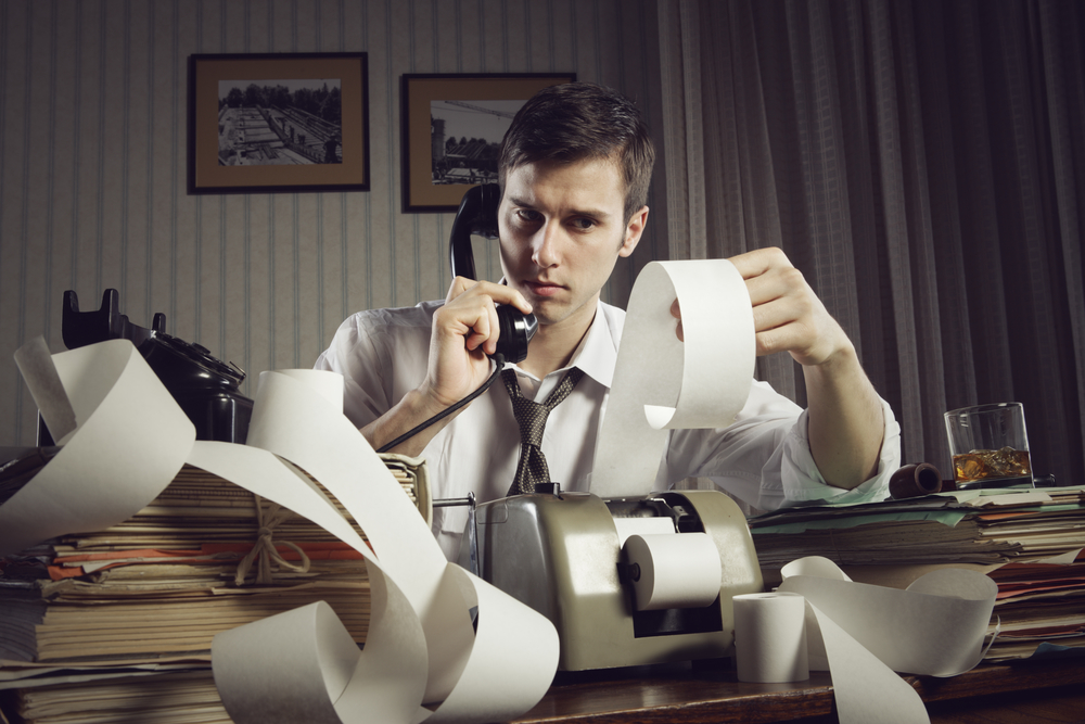 An male accountant at telephone  preparing income taxes