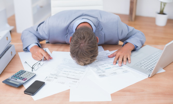 Businessman being depressed by accounting in his office