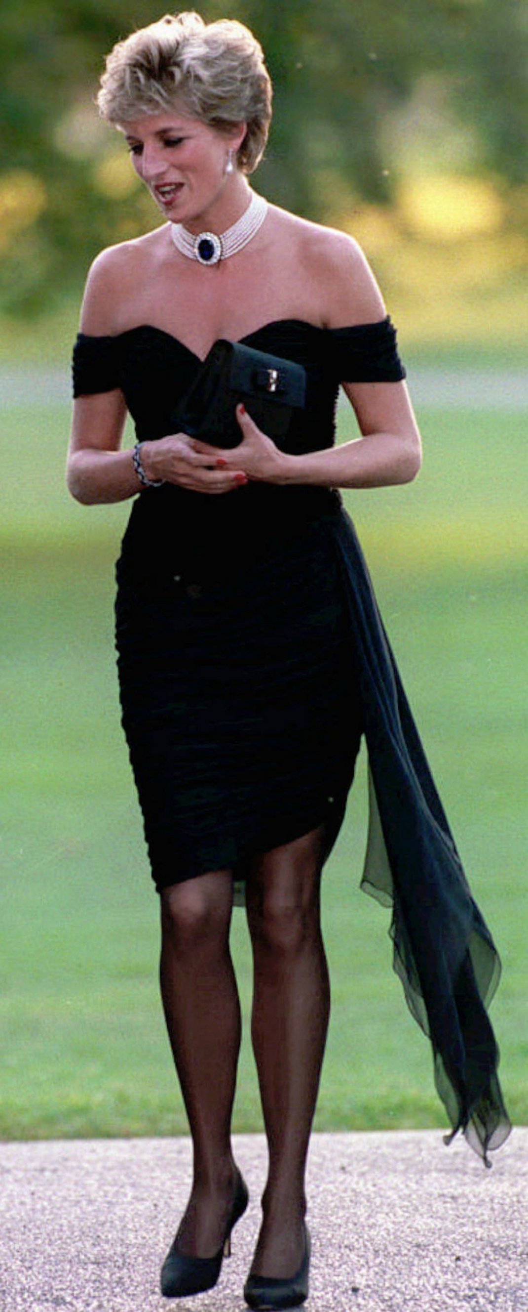 CAPTION CORRECTS DATE PHOTO WAS TAKEN TO 1994 FILE - In this 1994 file photo, Diana, Princess of Wales walks during a party given at the Serpentine Gallery in London. The same day that Charles admitted he was unfaithful to Diana during a TV interview, Diana appeared at the Serpentine Gallery in what was dubbed her revenge dress, a figure-hugging, low cut, off-the-shoulder little black outfit. (AP Photo/File)