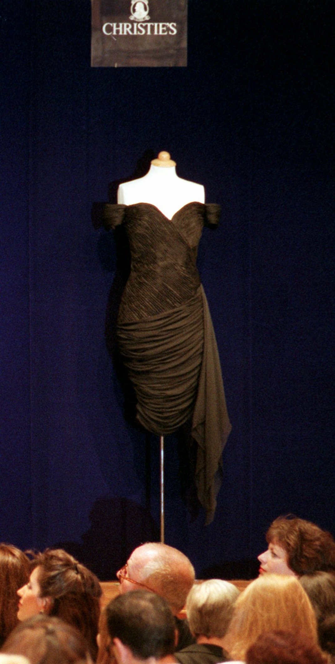 Christie's Auction house takes bids on the second evening gown from Princess Diana, a form-fitting, short-hemmed, black silk crepe by Christina Stambolian, which sold for $65,000 Wednesday, June 25, 1997, in New York. Diana wore this dress to a 1994 British Red Cross reception, her first high-profile appearance after Prince Charles acknowledged being unfaithful in a televised interview. Proceeds from the most talked-about celebrity auction since Jackie Onassis' heirlooms were up for bid will go to AIDSand cancer charities. (AP Photo/Ron Frehm)