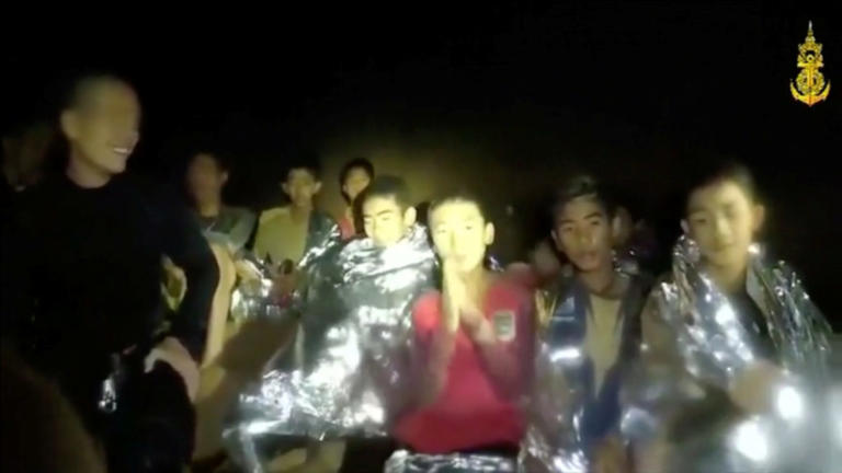 Boys from the under-16 soccer team trapped inside Tham Luang cave greet members of the Thai rescue team in Chiang Rai, Thailand, in this still image taken from a July 3, 2018 video by Thai Navy Seal. Thai Navy Seal/Handout via REUTERS TV    ATTENTION EDITORS - THIS IMAGE WAS PROVIDED BY A THIRD PARTY. NO RESALES. NO ARCHIVE.  MANDATORY CREDIT.