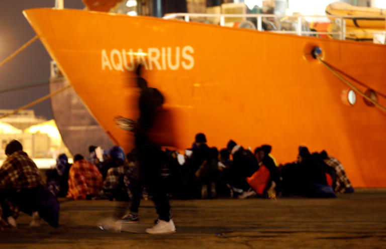 FILE PHOTO: Migrants disembark from the MV Aquarius, a search and rescue ship run in partnership between SOS Mediterranee and Medecins Sans Frontieres, after it arrived in Augusta on the island of Sicily, Italy, January 30, 2018. REUTERS/Antonio Parrinello/File Photo