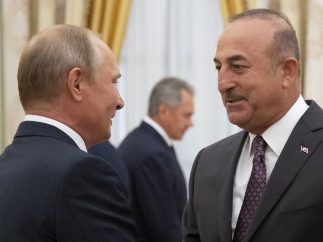 epa06968798 Russian President Vladimir Putin (L) speaks with Turkish Foreign Minister Mevlut Cavusoglu (R) during their meeting in the Kremlin in Moscow, Russia, 24 August 2018. Turkey's Foreign Minister on Friday warned against a possible Syrian government offensive on the last remaining stronghold of opposition against President Bashar Assad, while Russia indicated that it's losing its patience with the rebels.  EPA/ALEXANDER ZEMLIANICHENKO / POOL