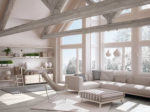 Living room of luxury eco house, parquet floor and wooden roof trusses, panoramic window on winter meadow, modern white interior design