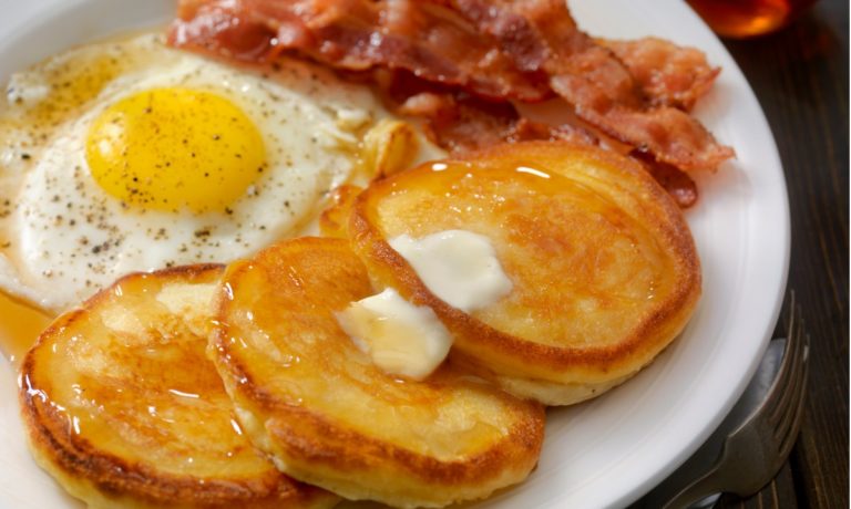 grand-slam-breakfast-pancakes-bacon-and-eggs-picture-id872530882-768x460